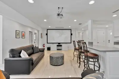 a living room with a couch and a tv at New cheerful villa, Pool, Spa, Mini Golf, Game room, Fire pit next to Disneyland in Anaheim