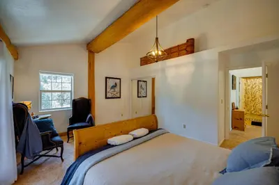 a bedroom with a large bed in a room at Pinon Pines Vacation Rental Hike, Bike and ATV! in Pine Mountain Club