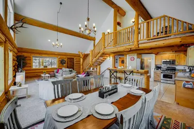a dining room and living room in a log cabin at Pinon Pines Vacation Rental Hike, Bike and ATV! in Pine Mountain Club