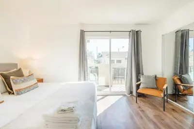 a white room with a bed and a chair at New Renovated Spacious 3 bedroom near DT Alhambra in Alhambra