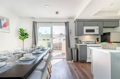a kitchen and dining room with a table and chairs at New Renovated Spacious 3 bedroom near DT Alhambra in Alhambra