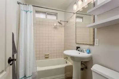 a bathroom with a sink and a tub and a toilet at Downtown Culver City House w/ Backyard, AC & Garage in Los Angeles