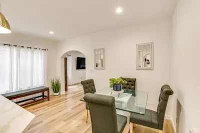 a dining room and living room with a glass table and chairs at 7 Mi to Dtwn! Modern Retreat in East Los Angeles in East Los Angeles