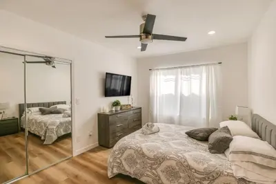 a bedroom with two beds and a mirror at 7 Mi to Dtwn! Modern Retreat in East Los Angeles in East Los Angeles