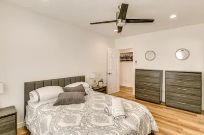 a bedroom with a bed and a ceiling fan at 7 Mi to Dtwn! Modern Retreat in East Los Angeles in East Los Angeles