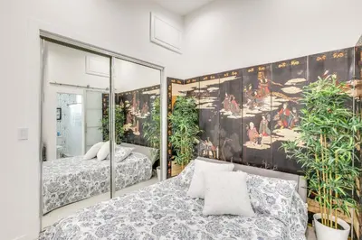 a bedroom with two beds and a mirror at 9 Mi to Dodger Stadium! East LA Studio with Patio in East Los Angeles