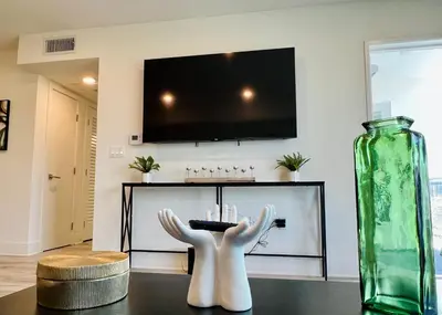 a living room with a tv and a vase on a table at Century City Chic 4 sleep free parking 402 in Los Angeles