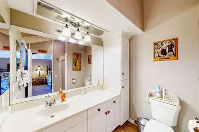 a bathroom with a sink and a toilet and a mirror at Fernrock Cabin in Twin Peaks