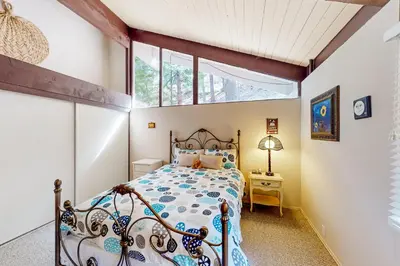 a bedroom with a bed and a window at Fernrock Cabin in Twin Peaks