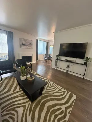 a living room with a large flat screen tv at Beverly Hills City Vibe 1 br Apt w Parking 324 in Los Angeles