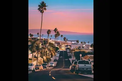 a street with cars parked on the road with palm trees at Beverly Hills City Vibe 1 br Apt w Parking 324 in Los Angeles
