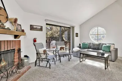 a living room with a couch and a fireplace at Restmoore Big Bear~ Lakeside Condo Retreat~ in Big Bear Lake
