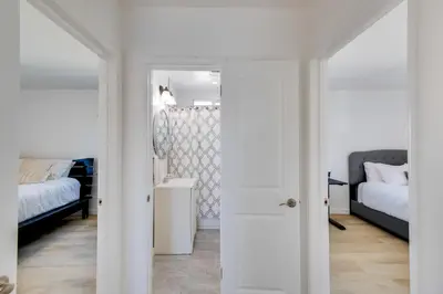 a bedroom with two beds and a door leading into a room at 5 Mi to Venice Beach Chic Los Angeles Abode in Los Angeles