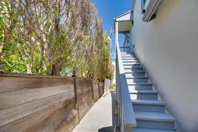 a stairway leading up to a building with trees at 5 Mi to Venice Beach Chic Los Angeles Abode in Los Angeles