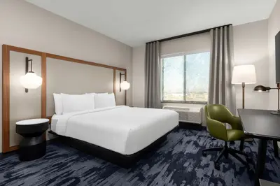 a hotel room with a bed and a desk at Fairfield by Marriott Inn & Suites Victorville in Victorville