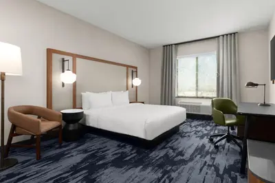 a hotel room with a bed and a desk at Fairfield by Marriott Inn & Suites Victorville in Victorville