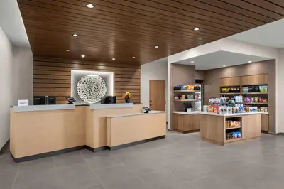 a lobby of a pharmacy with a counter and shelves at Fairfield by Marriott Inn & Suites Victorville in Victorville