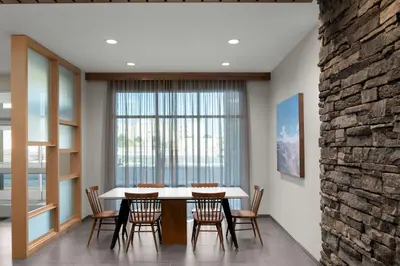 a dining room with a table and chairs and a large window at Fairfield by Marriott Inn & Suites Victorville in Victorville