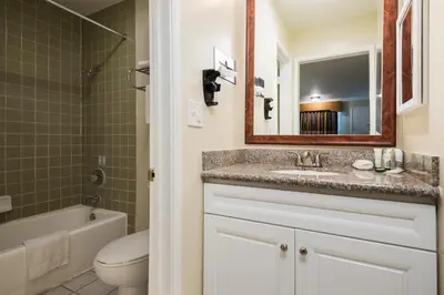 a bathroom with a sink and a toilet and a mirror at Bokai Garden Hotel in Rosemead