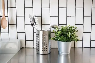 two metal containers with utensils sitting on a counter at Seaside Bliss -Downtown! Beach! ConvCenter! Bikes! in Long Beach