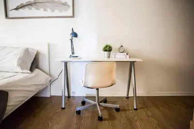 a desk with a chair next to a bed at Seaside Bliss -Downtown! Beach! ConvCenter! Bikes! in Long Beach