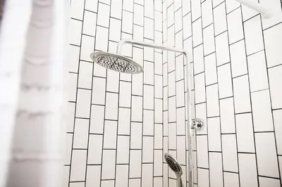 a shower with a shower head on a tiled wall at Seaside Bliss -Downtown! Beach! ConvCenter! Bikes! in Long Beach