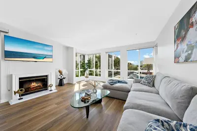 a living room with a couch and a fireplace at The Turquoise Lounge - Chic 2BR Beach view Pool, Sauna in Los Angeles
