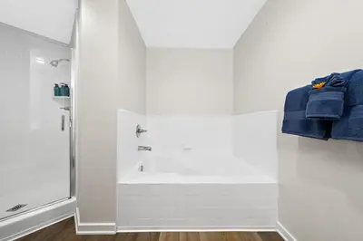 a white bathroom with a shower and a sink at The Turquoise Lounge - Chic 2BR Beach view Pool, Sauna in Los Angeles