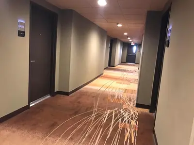 an empty corridor of an office with black walls at GreenTree Inn & Suites Los Angeles - Alhambra - Pasadena in Alhambra