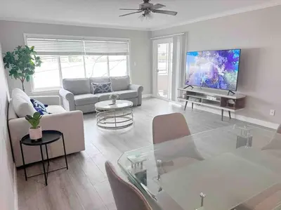 a living room with a couch and a tv at Spacious South Bay Condo in Torrance