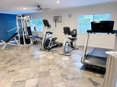 a gym with treadmills and exercise equipment in a room at Spacious South Bay Condo in Torrance