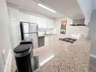 a kitchen with a refrigerator and a counter top at Spacious South Bay Condo in Torrance