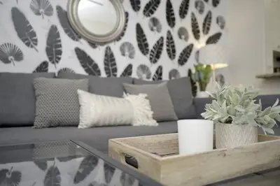 a living room with a gray couch and a table at LBC Cozy Suite -Downtown! Beach! in Long Beach