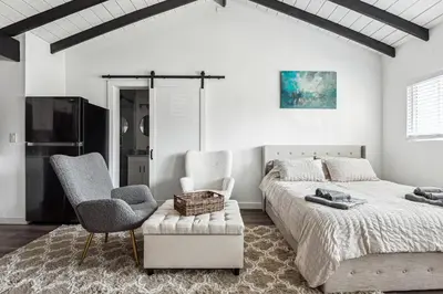 a bedroom with a large bed and two chairs at Private Studio Oasis with Nature at Your Doorstep in Thousand Oaks