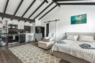 a bedroom with a large bed and a kitchen at Private Studio Oasis with Nature at Your Doorstep in Thousand Oaks