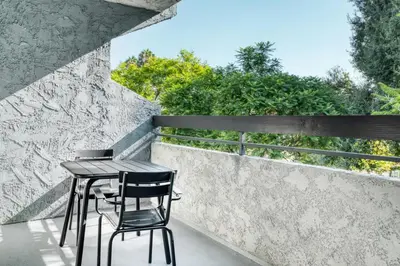 a table and two chairs sitting on a balcony at Pasadena 1BR w gym pool nr Colorado Ave LAX-861 in Pasadena