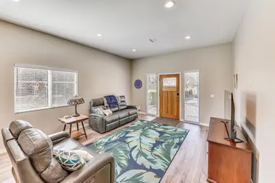 a living room with a couch and a tv at Peaceful Riverside Home with Patio, 7 Mi to Downtown in Riverside