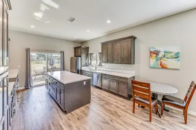 a kitchen with a table and chairs and a table and a counter at Peaceful Riverside Home with Patio, 7 Mi to Downtown in Riverside