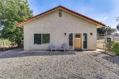 a small house with two chairs in front of it at Peaceful Riverside Home with Patio, 7 Mi to Downtown in Riverside