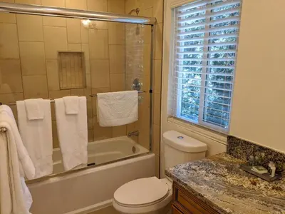 a bathroom with a tub and a toilet and a sink at “The Grey Haven” – Secluded home in the woods in Lake Arrowhead
