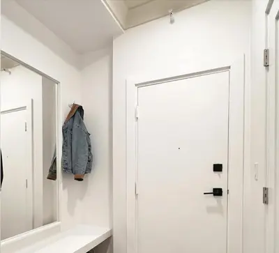 a white hallway with a mirror and a door at New York Style 1bed 1bath West Hollywood in Los Angeles