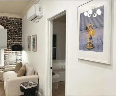 a living room with a yellow fire hydrant on the wall at New York Style 1bed 1bath West Hollywood in Los Angeles