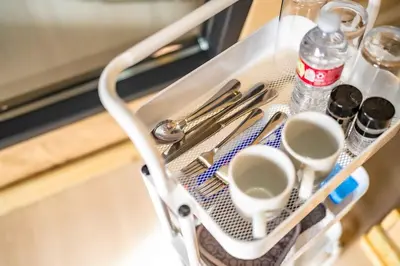 a tray with cups and utensils and a bottle of water at Glamping in the Urban in Glendora