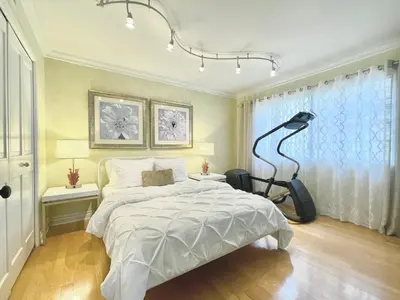 a bedroom with a bed and a black lamp at CASA LUX MONICA Prime Santa Monica Luxury Home ONE-OF-A-KIND in Los Angeles