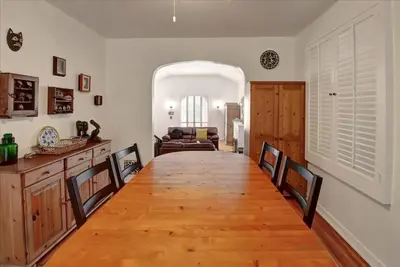 a dining room with a long table and a couch at Hollywood-Sign Griffith-Observatory & Park Kng Bed in Los Angeles