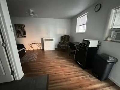 an empty living room with a table and a chair at LittleBetty's LandingPad in Torrance