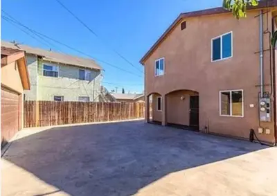an empty parking lot in front of a house at Big & Cozy Duplex Home in Los Angeles