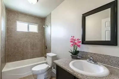 a bathroom with a sink and a toilet and a mirror at Big & Cozy Duplex Home in Los Angeles