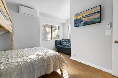 a bedroom with a bed and a couch at Lakehouse Retreat - Community Pool, Lake Views and Walk to Village! in Big Bear Lake