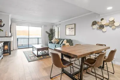 a living room with a table and a couch at Lakehouse Retreat - Community Pool, Lake Views and Walk to Village! in Big Bear Lake